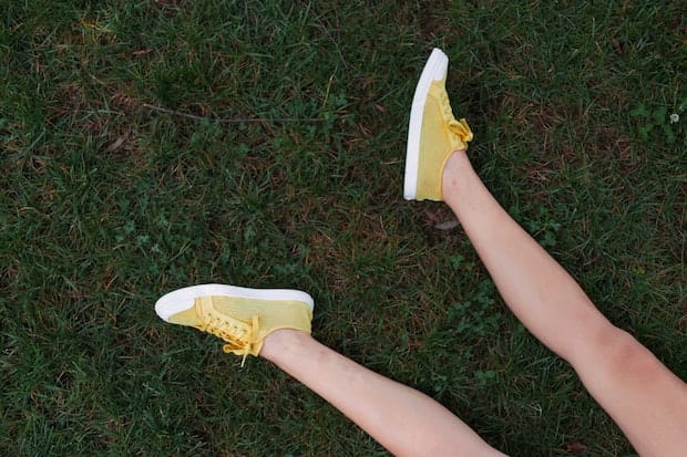 legs with yellow shoes on