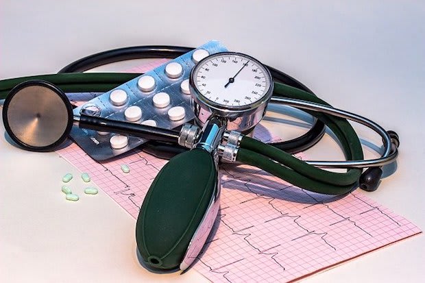 a stethoscope on top of blood pressure readings