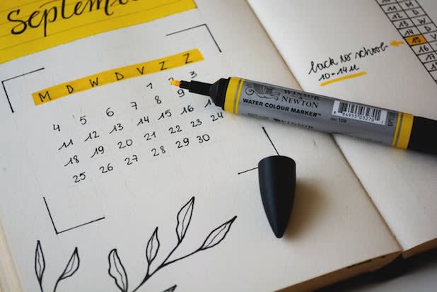 a paper calendar with a yellow marker