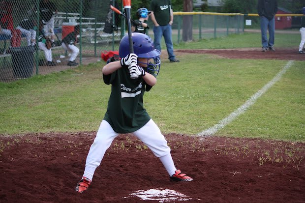 A young child playing little league baseball