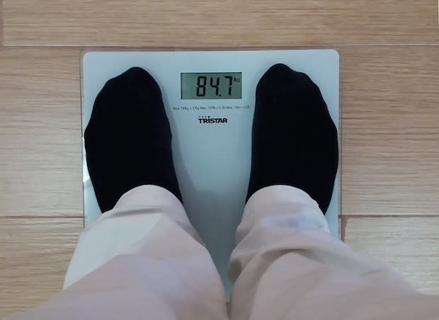 Feet standing on a set of scales