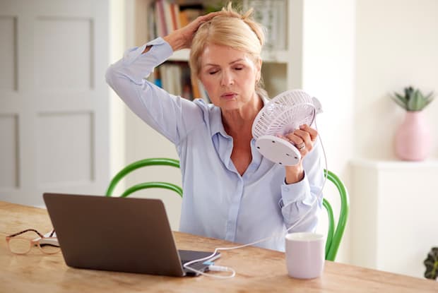 a woman using a fan 