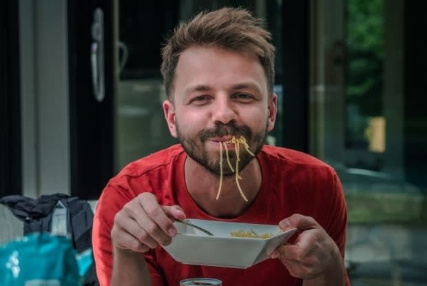 a man eating spaghetti