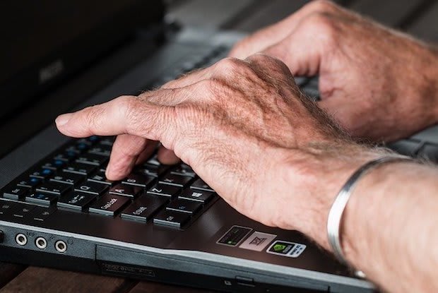 a man typing on a laptop