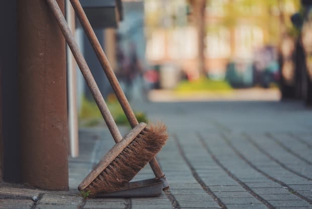 a broom and dustpan up against a wall