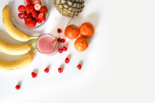 bananas, strawberries, and oranges on a white background