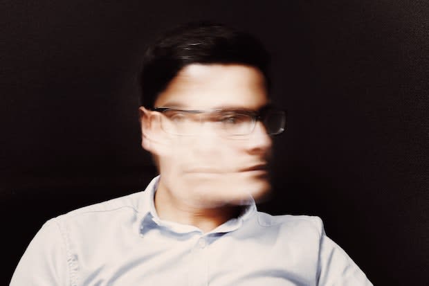 a man with an obscured, blurry face