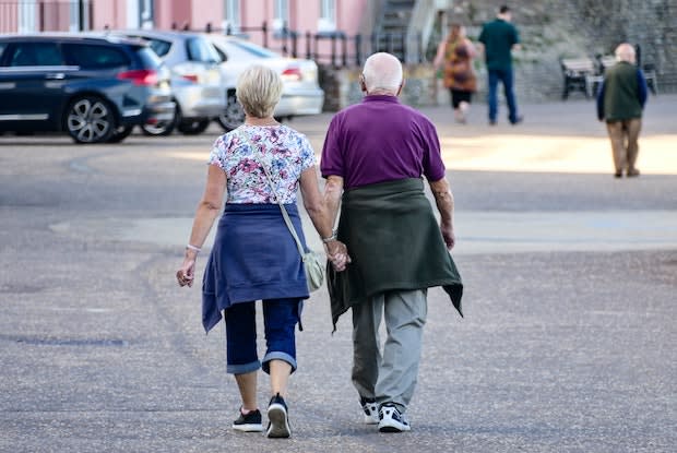 two older people walking together