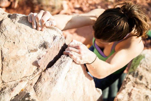 a woman rock-climbing