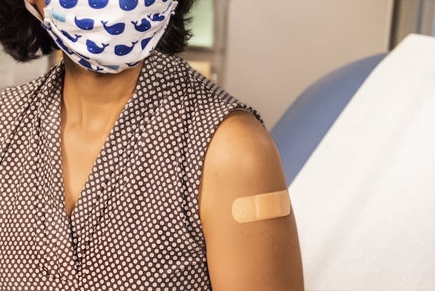 a woman with a band-aid on her arm