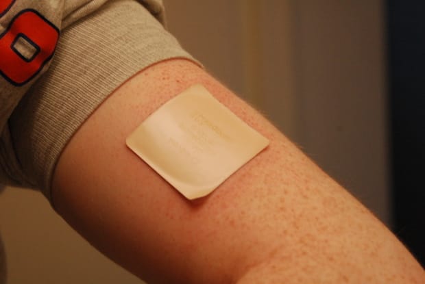 Close up of a nicotine patch on an arm