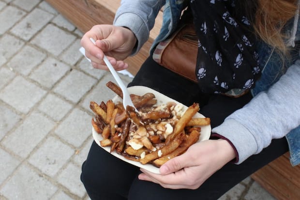 a person eating poutine