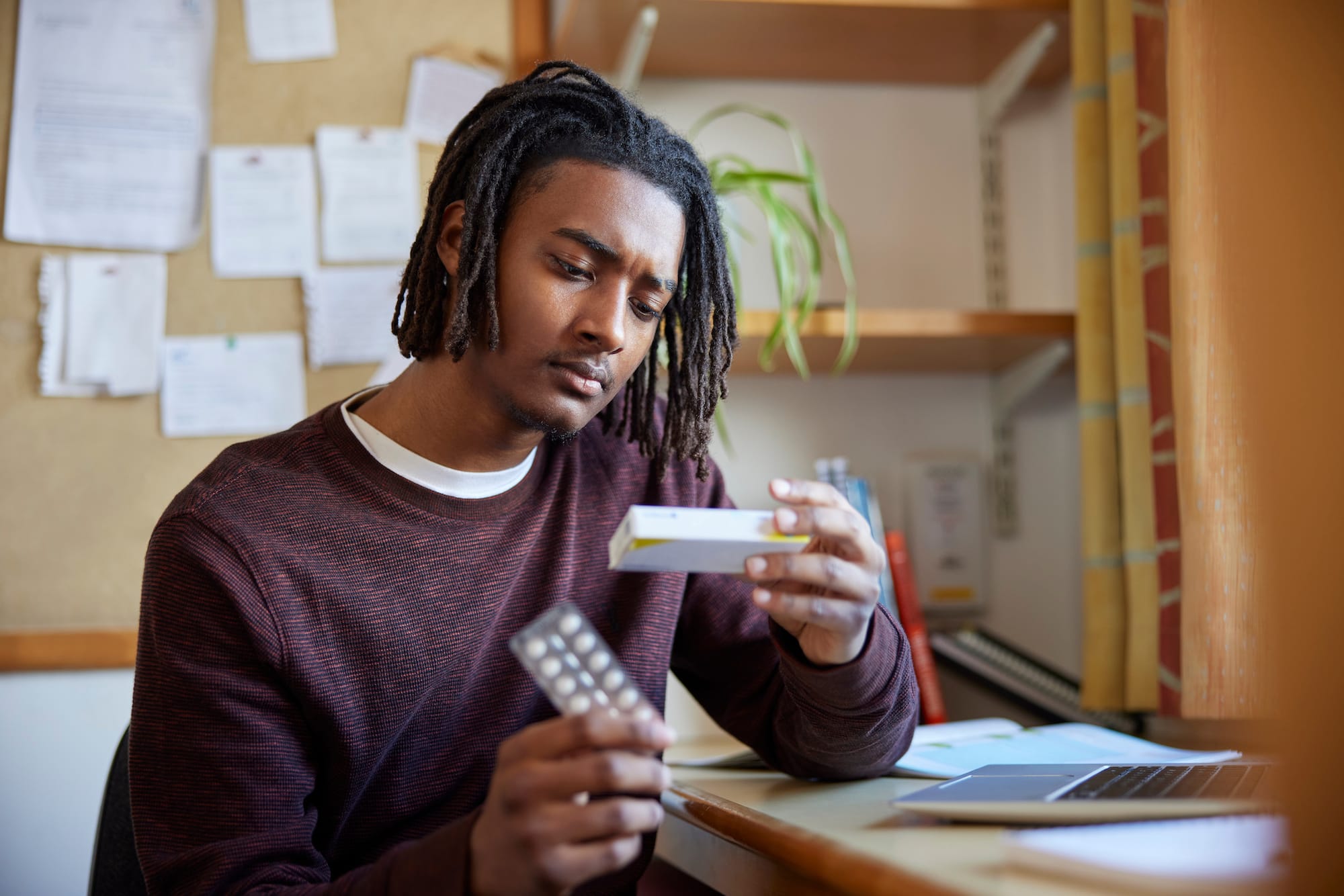 a person reading the side effects on the label of his medication