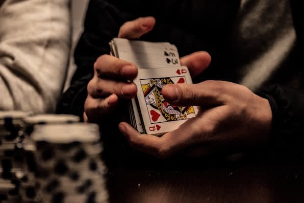 a person shuffling a deck of cards