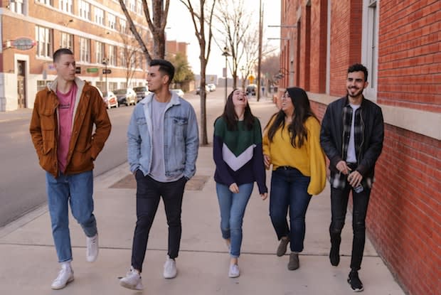 a group of teenagers walking down the street