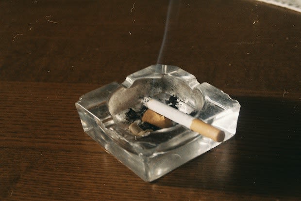 a cigarette in an ash tray