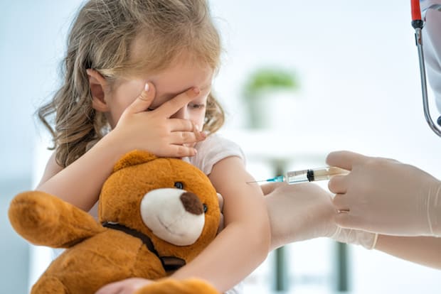 a little girl receiving a vaccination