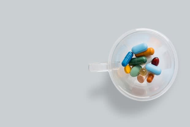 a cup filled with different medication