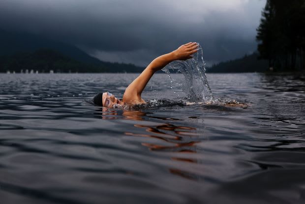 a person swimming in a lake