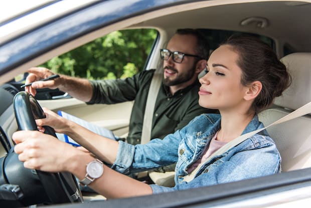 a woman driving a man 