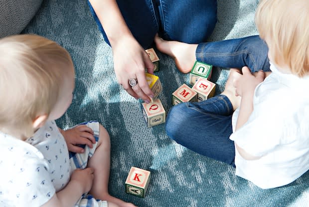 a mother playing with toddlers