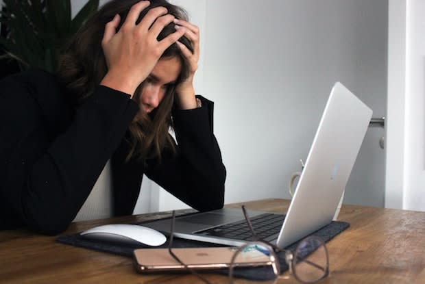 a woman looking stressed at a computer