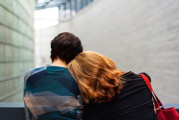 two partners embracing on a balcony