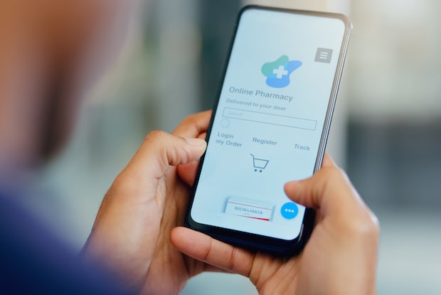 a man looking at ordering from an online Canadian pharmacy from his phone