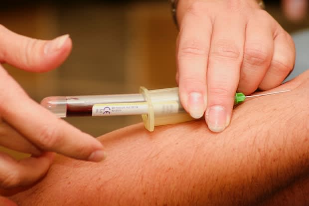 a doctor taking a blood sample