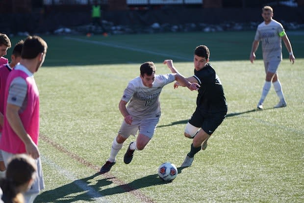 two men playing soccer