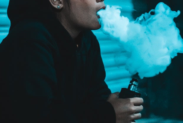 a woman exhaling smoke