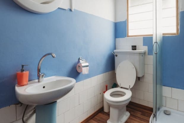 a bathroom with blue and white walls