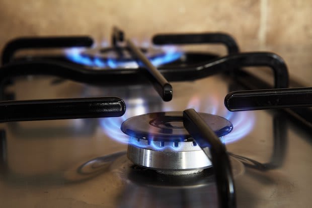 Two lit hobs on a gas stove