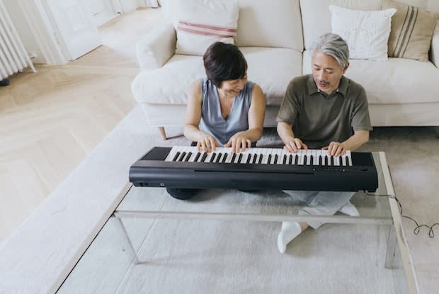 a couple playing the piano