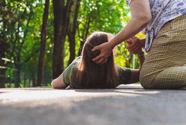 a man helping a girl having a seizure