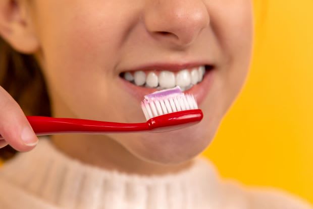 a woman brushing her teeth