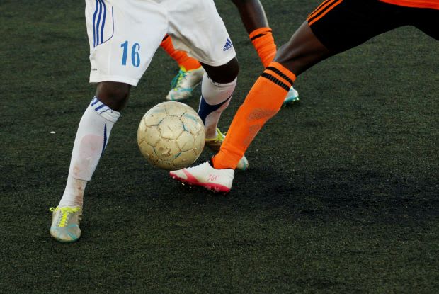 two people playing soccer