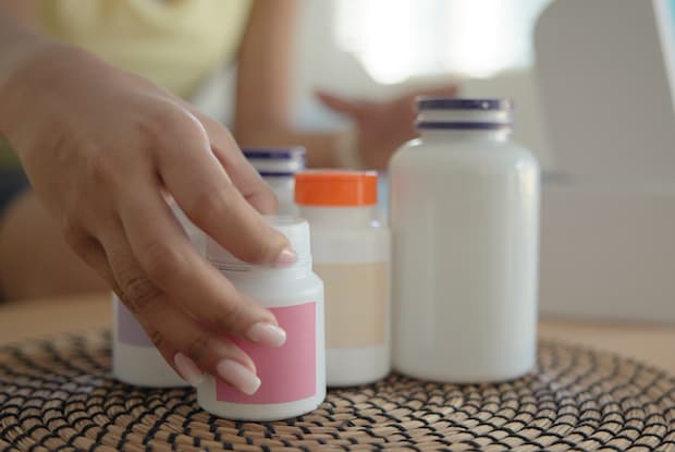 A woman taking prescription medications out of a package