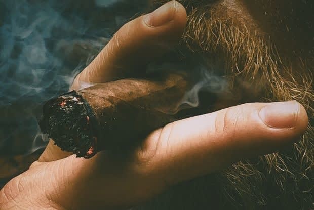 bearded man smoking cigar