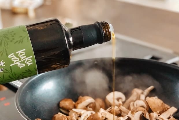 olive oil being poured on mushrooms