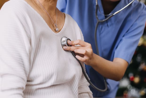 a doctor listening to a heartbeat