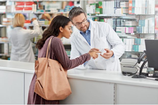 a woman getting retin-a from pharmacist