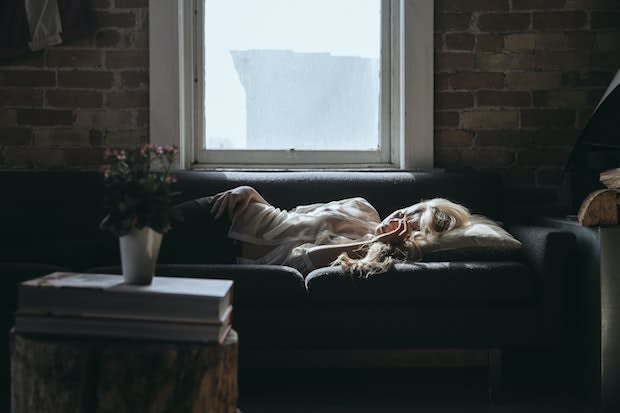 a woman lying down on a couch