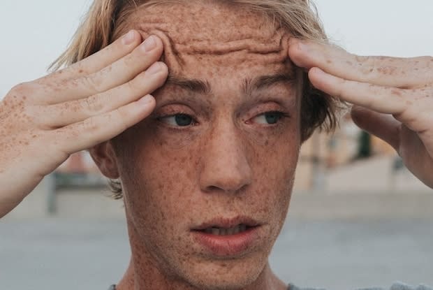 a man holding his head in agitation