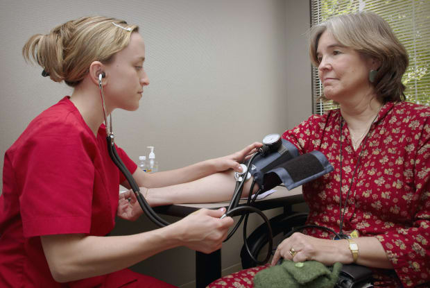 a woman having her blood pressure taken