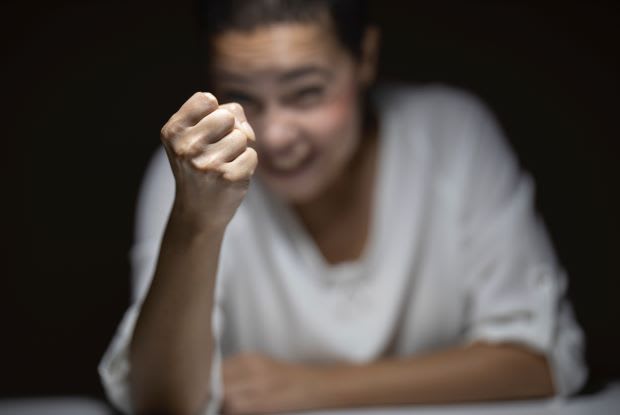 a woman forming a fist