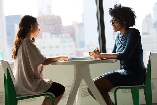 two people talking across a table