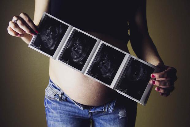 a woman holding some scans