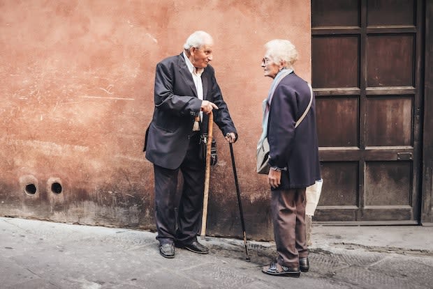 two older people talking with each other