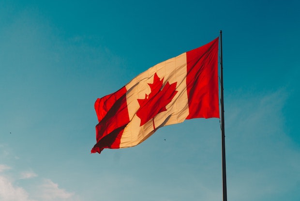 a Canadian flag flying in the wind